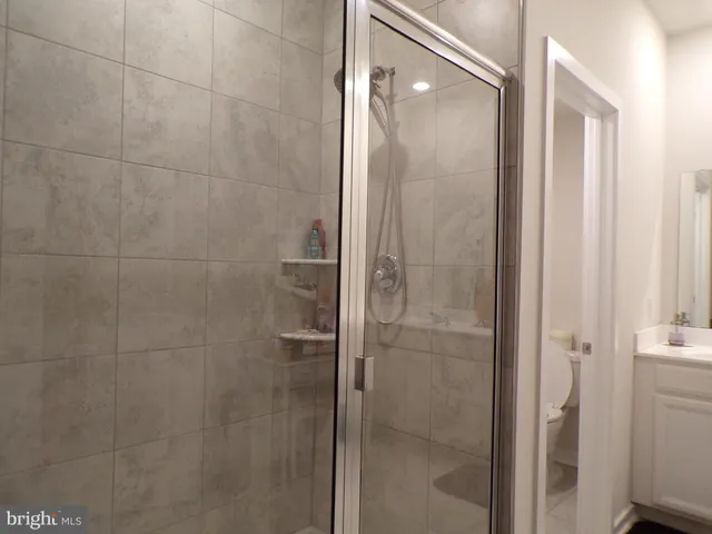 a bathroom with a glass shower door