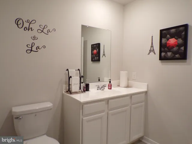 a living room with a bed furniture and a flat screen tv