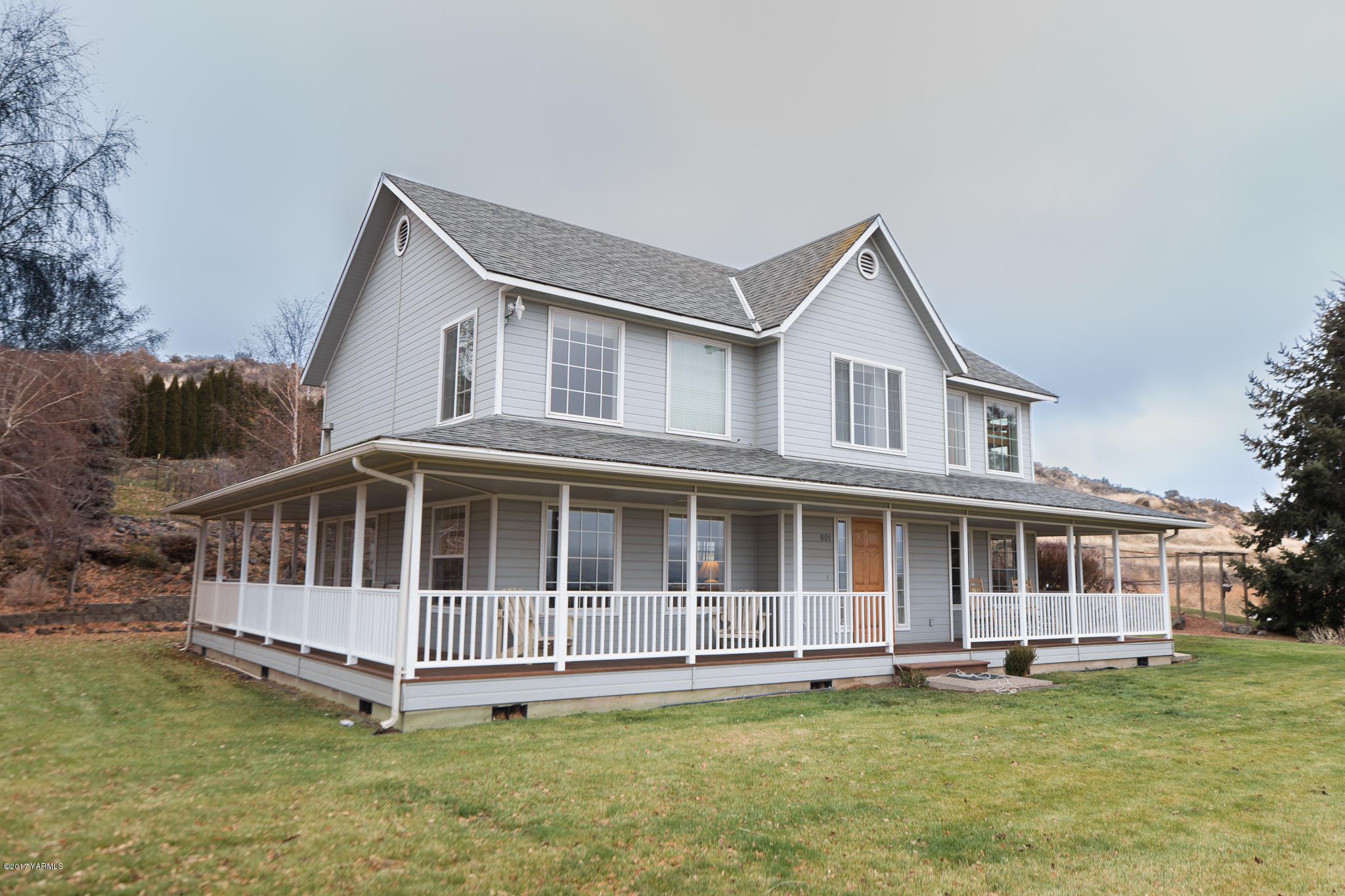 a view of a house with a yard and sitting area
