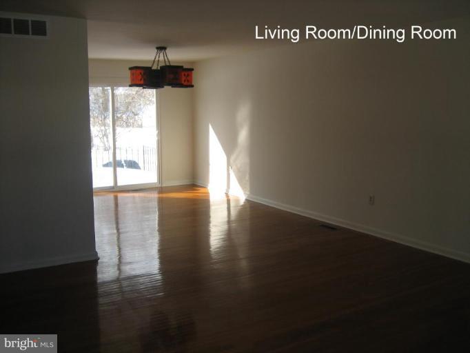 3918 Algiers Road Randallstown, MD 21133 - Photo 2 of 17 a view of a room with wooden floor and windows