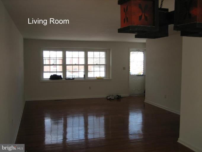 3918 Algiers Road Randallstown, MD 21133 - Photo 9 of 17 a view of wooden floor and a chair in a room