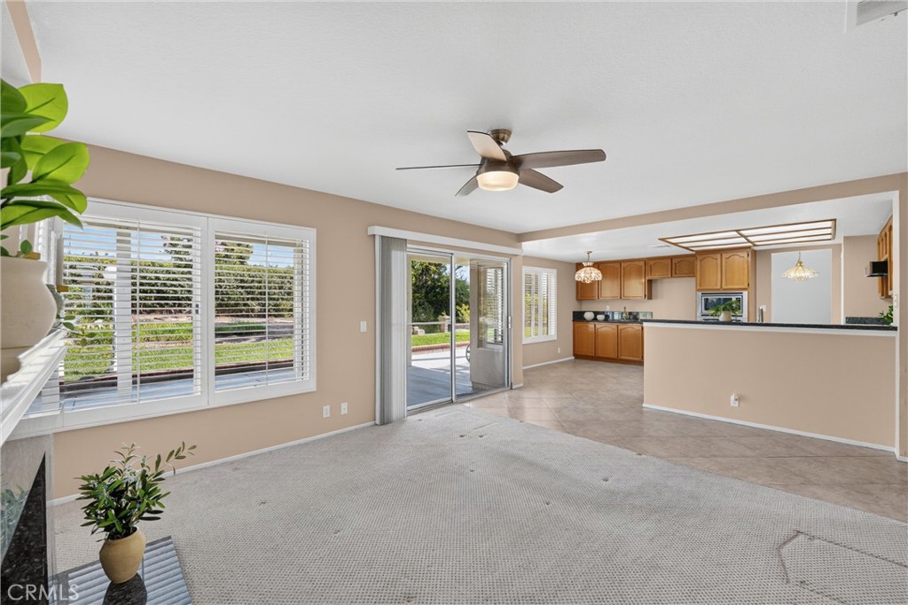 2000 Citrus Wood Lane Riverside, CA 92503 - Photo 22 of 51 Plantation Shutters, Ceiling Fan and view into kitchen, view of the outdoors.