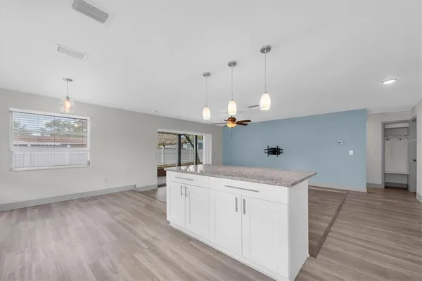 a view of a kitchen sink and wooden floor