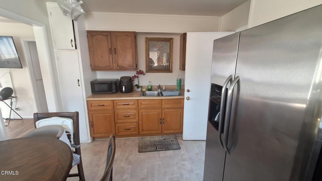 60 Princeton Avenue Oxnard, CA 93036 - Photo 5 of 10 a kitchen with a refrigerator sink and cabinets