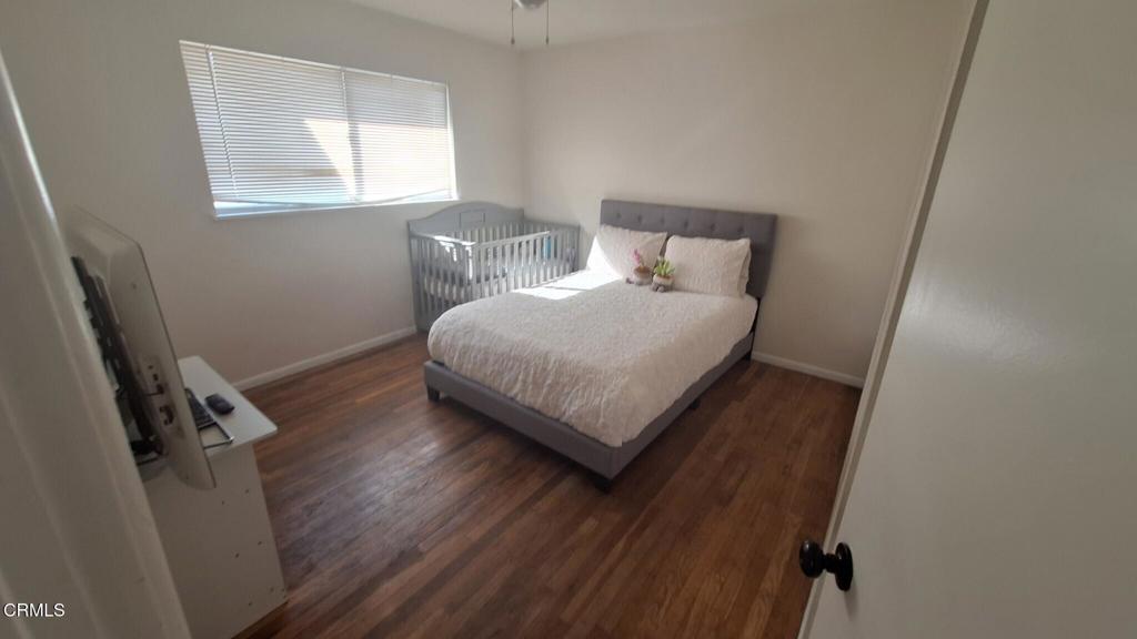 60 Princeton Avenue Oxnard, CA 93036 - Photo 6 of 10 a bedroom with a bed window and wooden floor