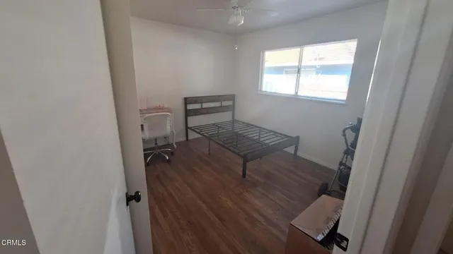 a reading room with wooden floor and a window
