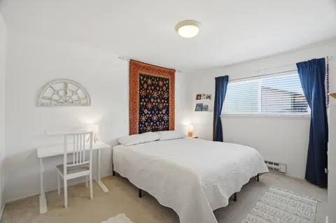 a bedroom with a bed and a table in it