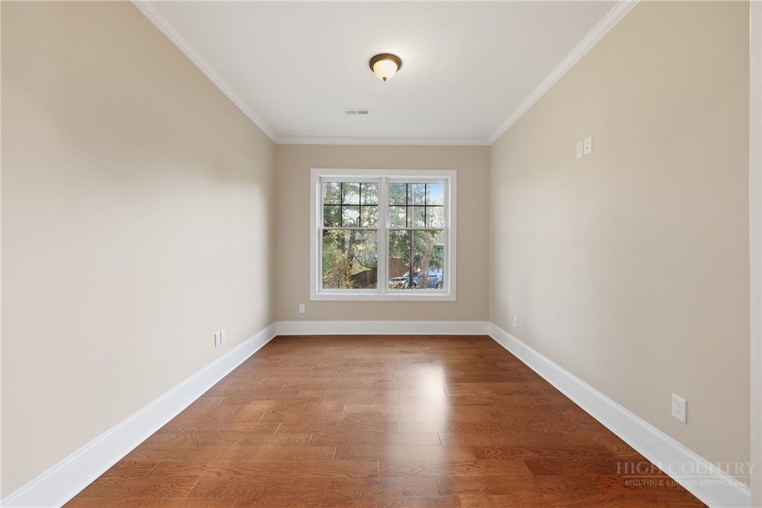 155 Gateway Drive, Unit 102 Boone, NC 28607 - Photo 11 of 43 an empty room with wooden floor and windows