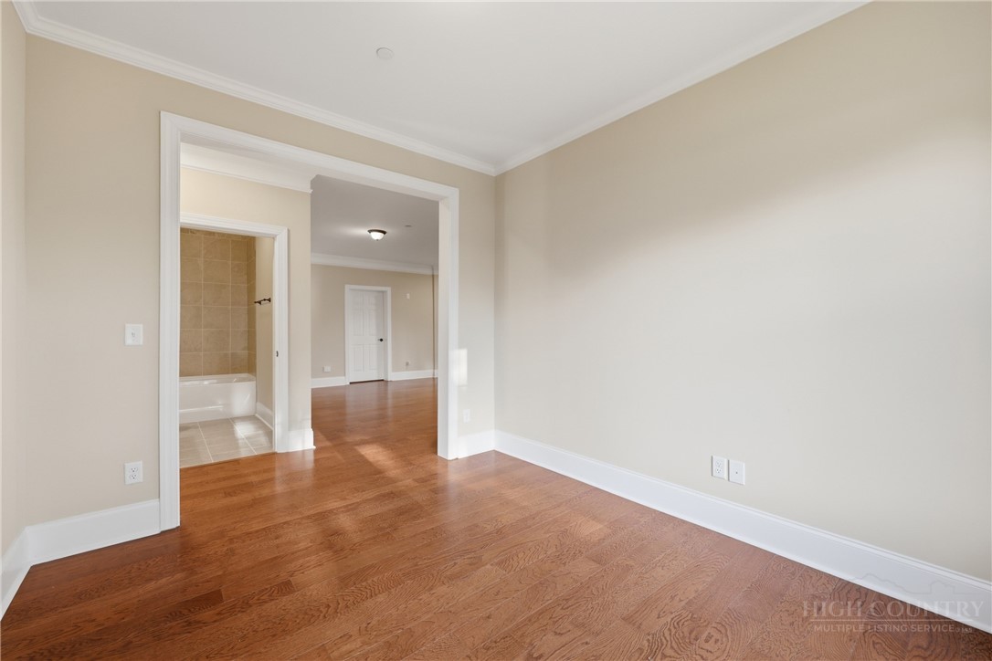 155 Gateway Drive, Unit 102 Boone, NC 28607 - Photo 12 of 43 a view of an empty room and wooden floor