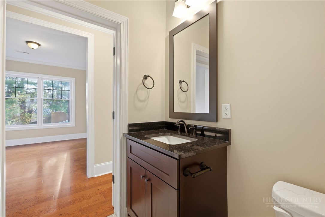 155 Gateway Drive, Unit 102 Boone, NC 28607 - Photo 14 of 43 a bathroom with a granite countertop sink and a mirror