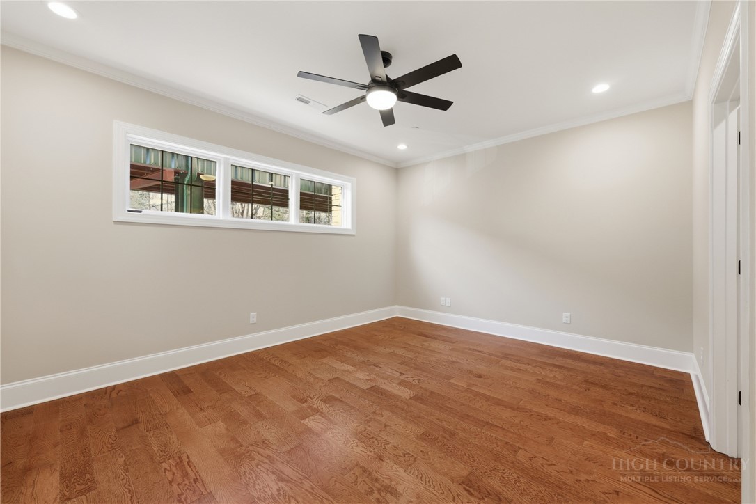 155 Gateway Drive, Unit 102 Boone, NC 28607 - Photo 18 of 43 wooden floor in an empty room with a window