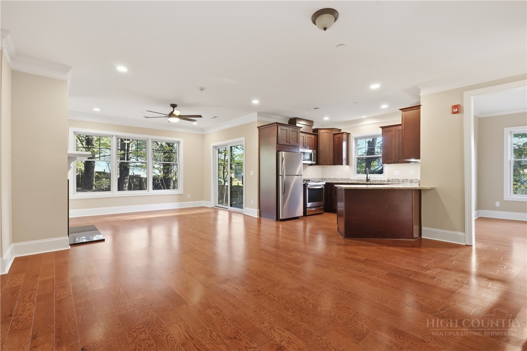 155 Gateway Drive, Unit 102 Boone, NC 28607 - Photo 2 of 43 a view of kitchen with stainless steel appliances kitchen island wooden floor and window