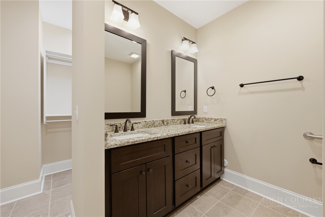155 Gateway Drive, Unit 102 Boone, NC 28607 - Photo 24 of 43 a bathroom with double sink and a mirror