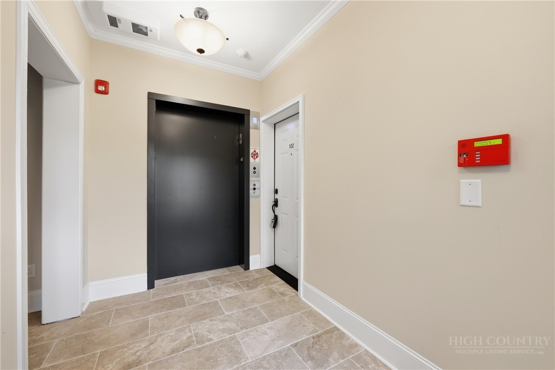 155 Gateway Drive, Unit 102 Boone, NC 28607 - Photo 30 of 43 a view of a hallway with wooden floor