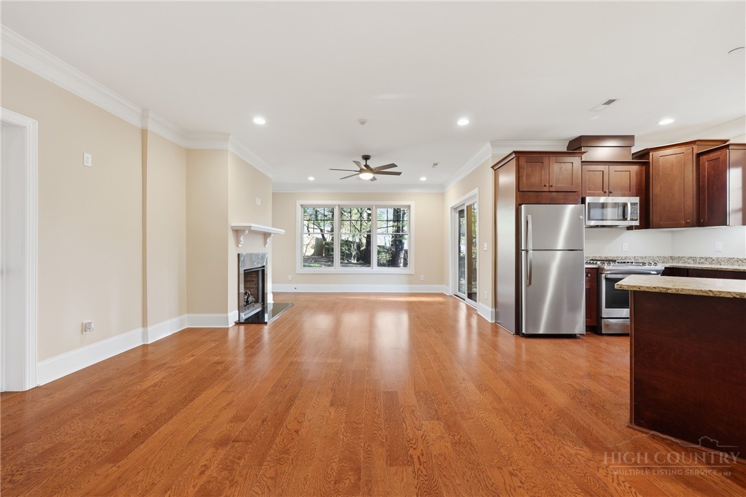 155 Gateway Drive, Unit 102 Boone, NC 28607 - Photo 3 of 43 a view of kitchen with stainless steel appliances a refrigerator and wooden floor