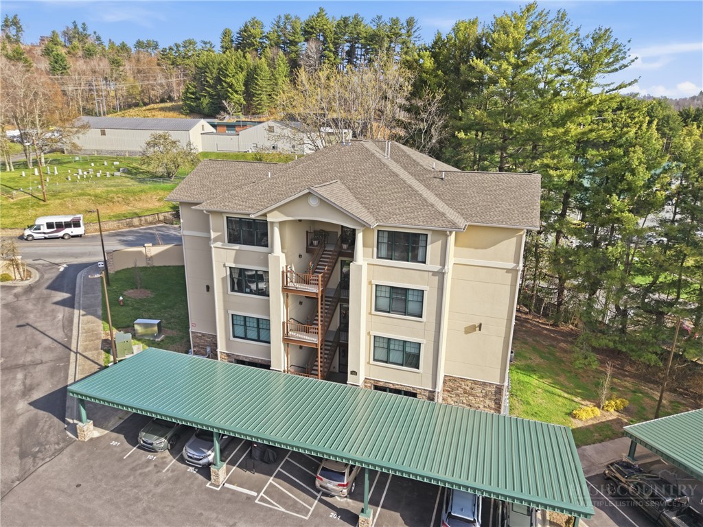 155 Gateway Drive, Unit 102 Boone, NC 28607 - Photo 33 of 43 a view of a house with a patio and a yard