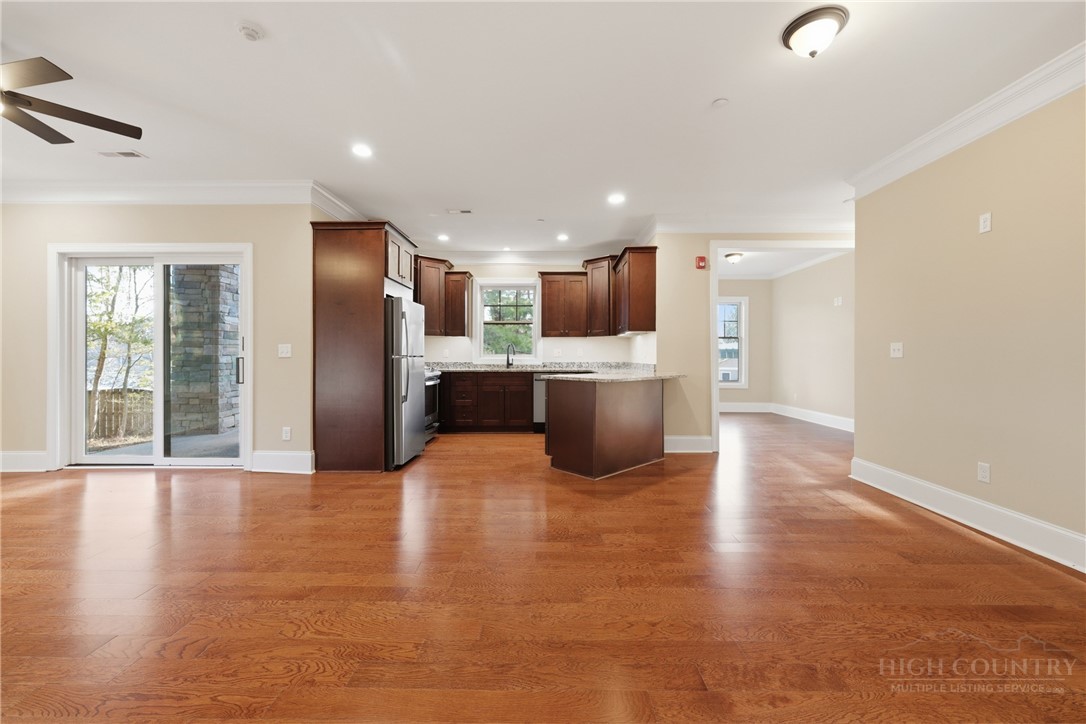 155 Gateway Drive, Unit 102 Boone, NC 28607 - Photo 4 of 43 a view of kitchen with stainless steel appliances granite countertop a refrigerator a sink dishwasher and a oven with wooden floor