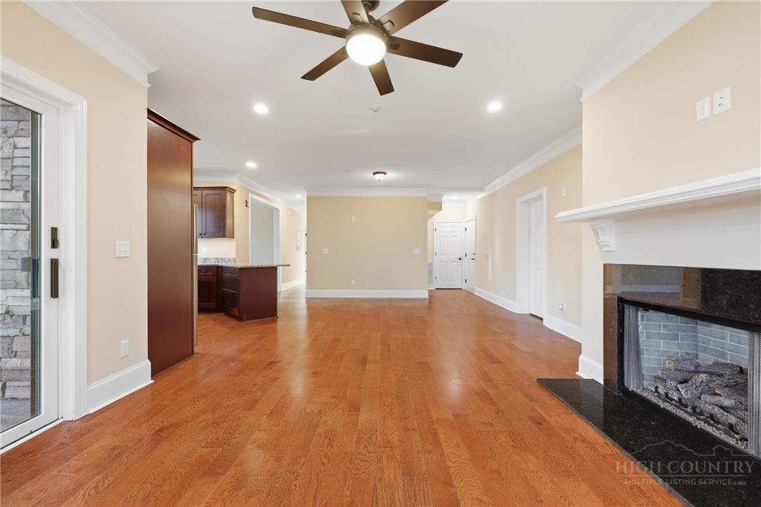 155 Gateway Drive, Unit 102 Boone, NC 28607 - Photo 5 of 43 a view of empty room with wooden floor and a fireplace