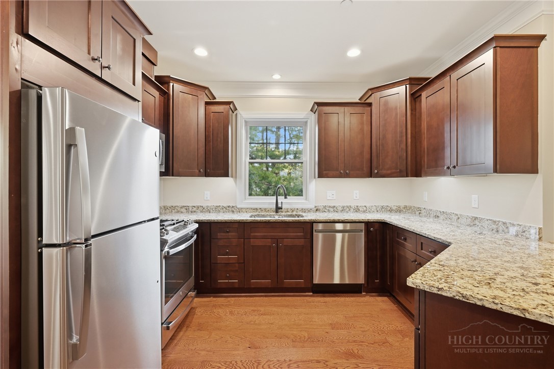 155 Gateway Drive, Unit 102 Boone, NC 28607 - Photo 7 of 43 a kitchen with stainless steel appliances granite countertop a refrigerator and a sink