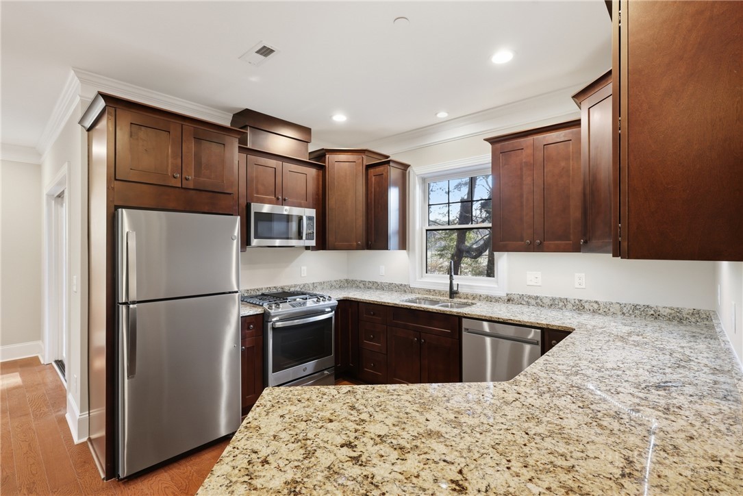 155 Gateway Drive, Unit 102 Boone, NC 28607 - Photo 8 of 43 a kitchen with stainless steel appliances granite countertop a sink stove and refrigerator