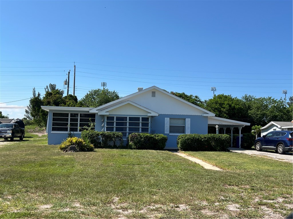 3716 Atlantic Boulevard Vero Beach, FL 32960 - Photo 1 of 22 a front view of house with yard and green space