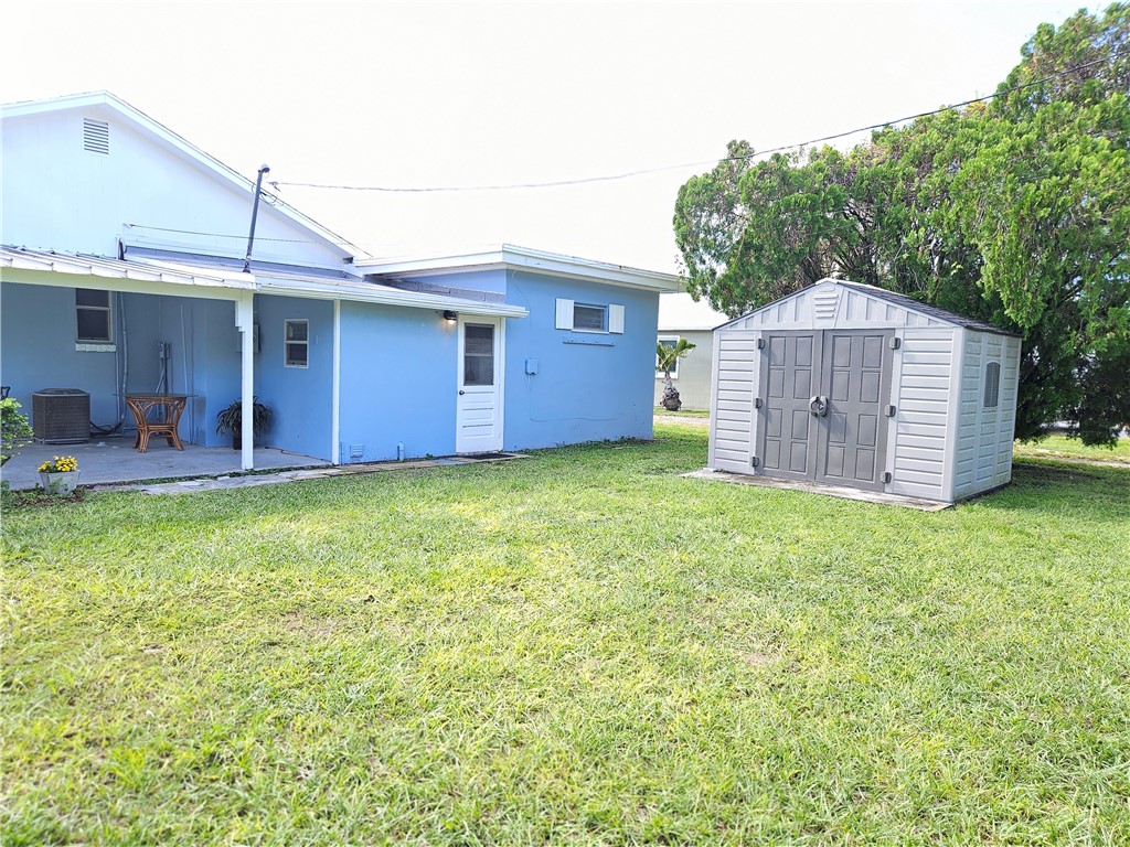 3716 Atlantic Boulevard Vero Beach, FL 32960 - Photo 22 of 22 a front view of a house with a garden and yard