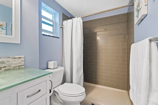 a bathroom with a toilet a sink and shower