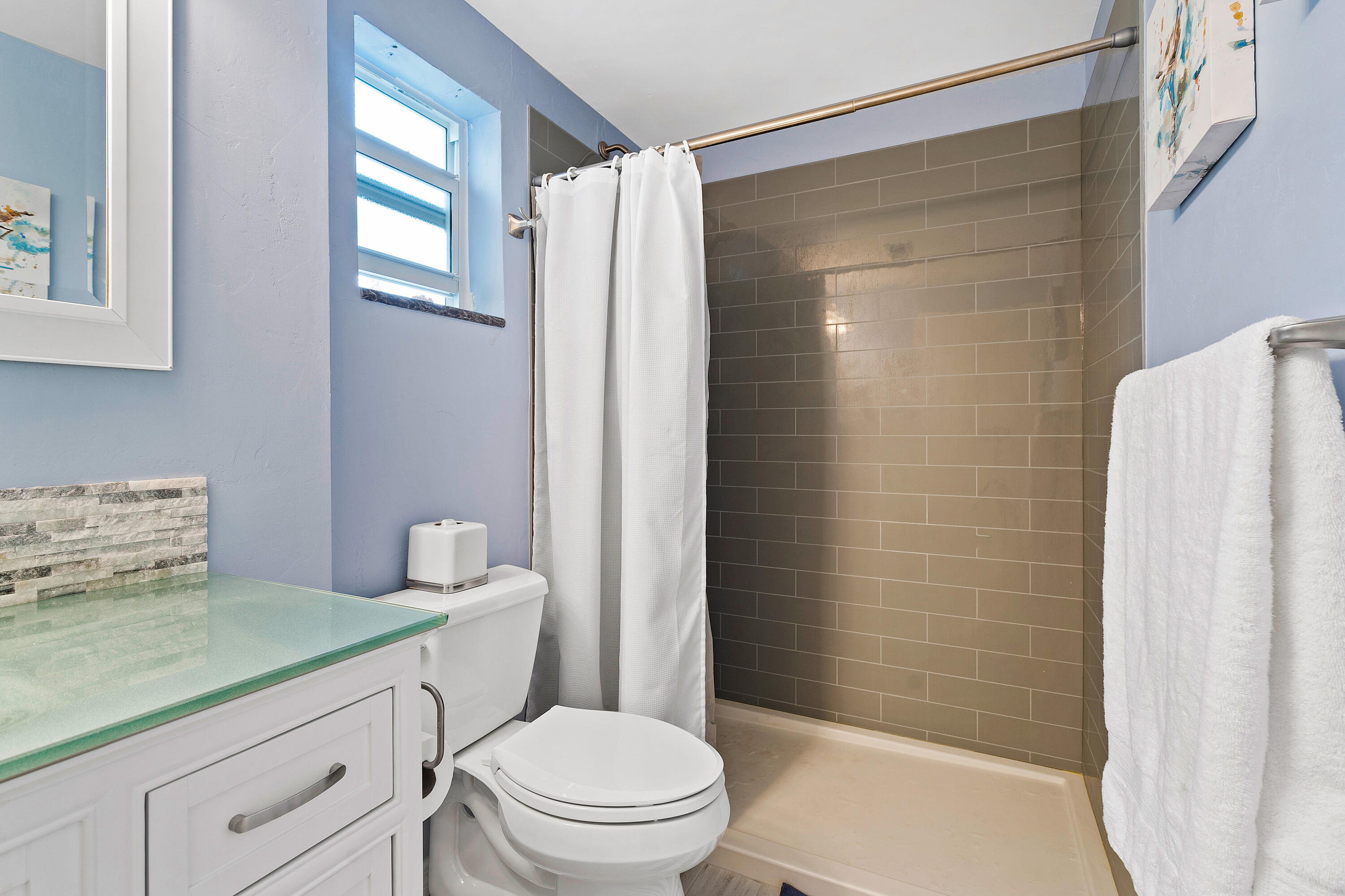 1030 Langer Way, Unit 5 Delray Beach, FL 33483 - Photo 12 of 21 a bathroom with a toilet a sink and shower