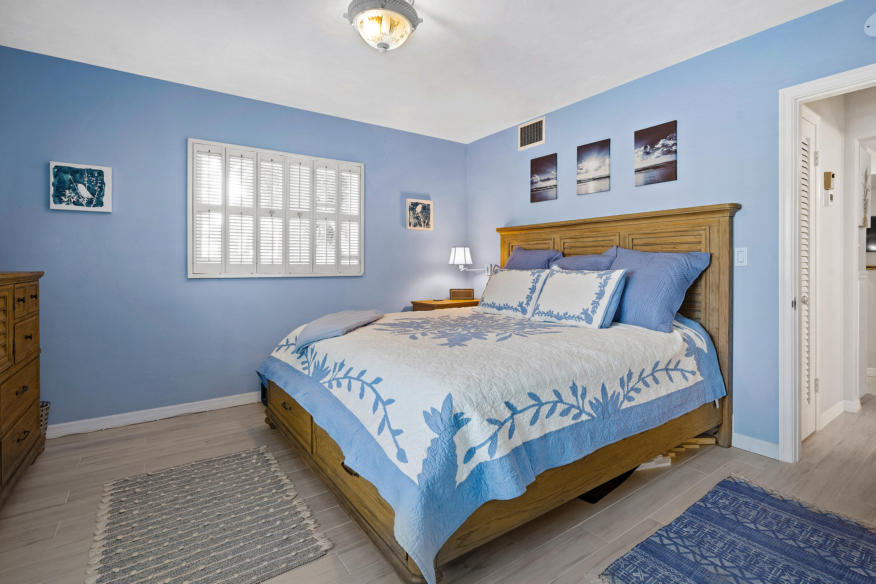 1030 Langer Way, Unit 5 Delray Beach, FL 33483 - Photo 13 of 21 a large bed sitting in a bedroom next to a window