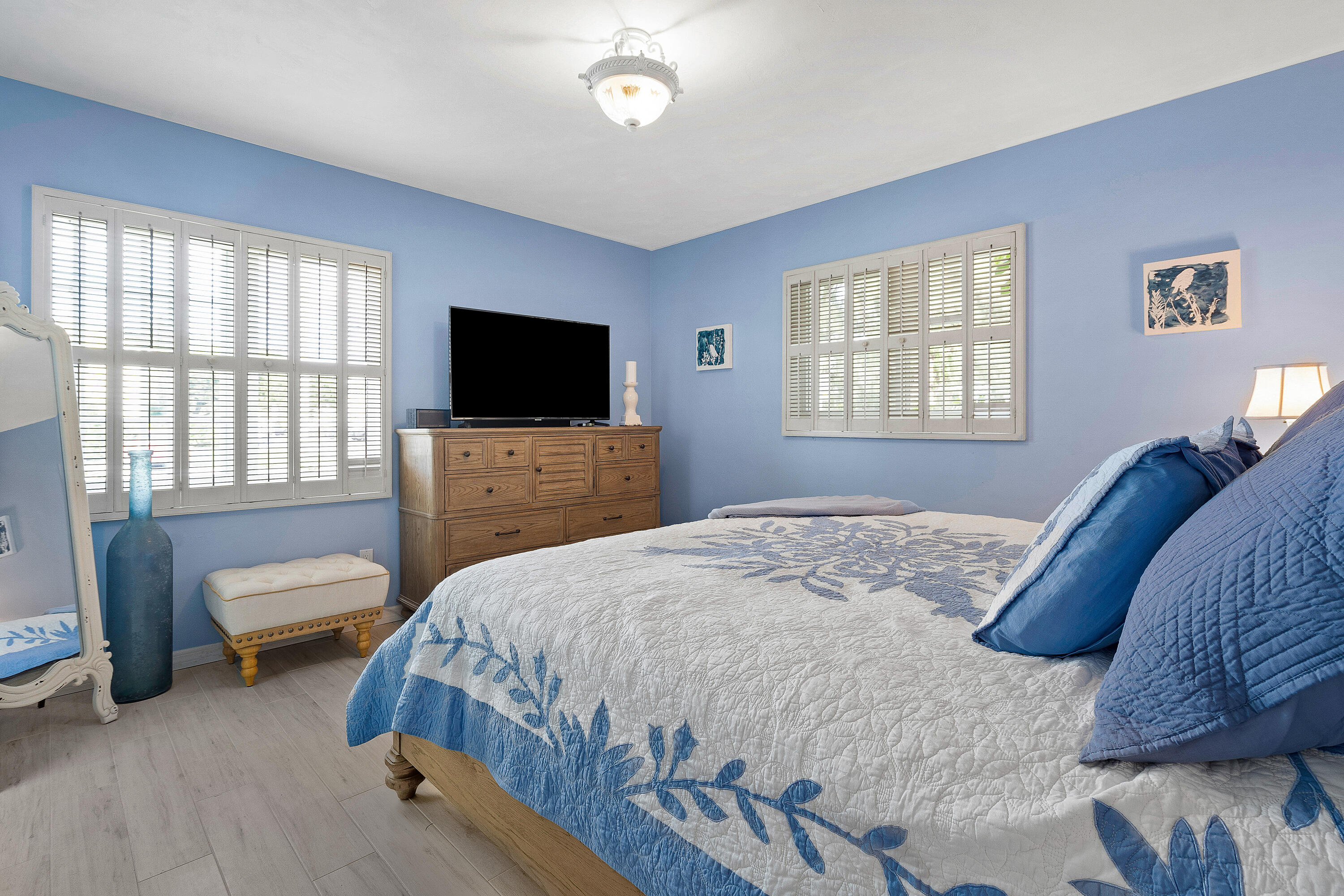 1030 Langer Way, Unit 5 Delray Beach, FL 33483 - Photo 14 of 21 a bedroom with a bed and a flat screen tv