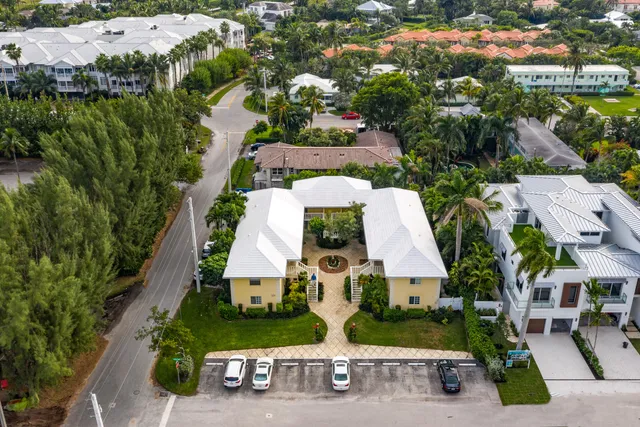 an aerial view of residential houses with outdoor space and street view