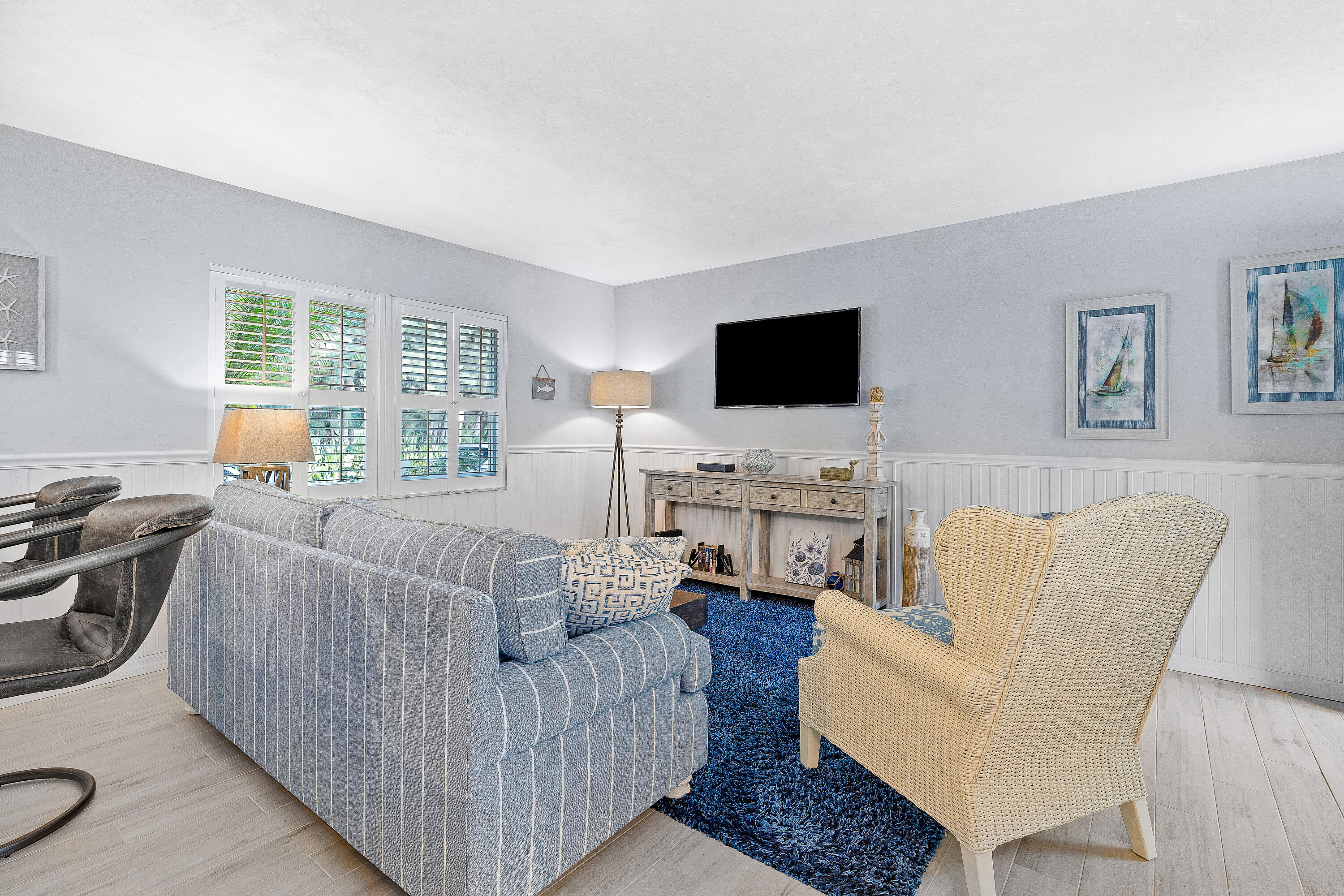 1030 Langer Way, Unit 5 Delray Beach, FL 33483 - Photo 3 of 21 a living room with furniture a flat screen tv and a large window