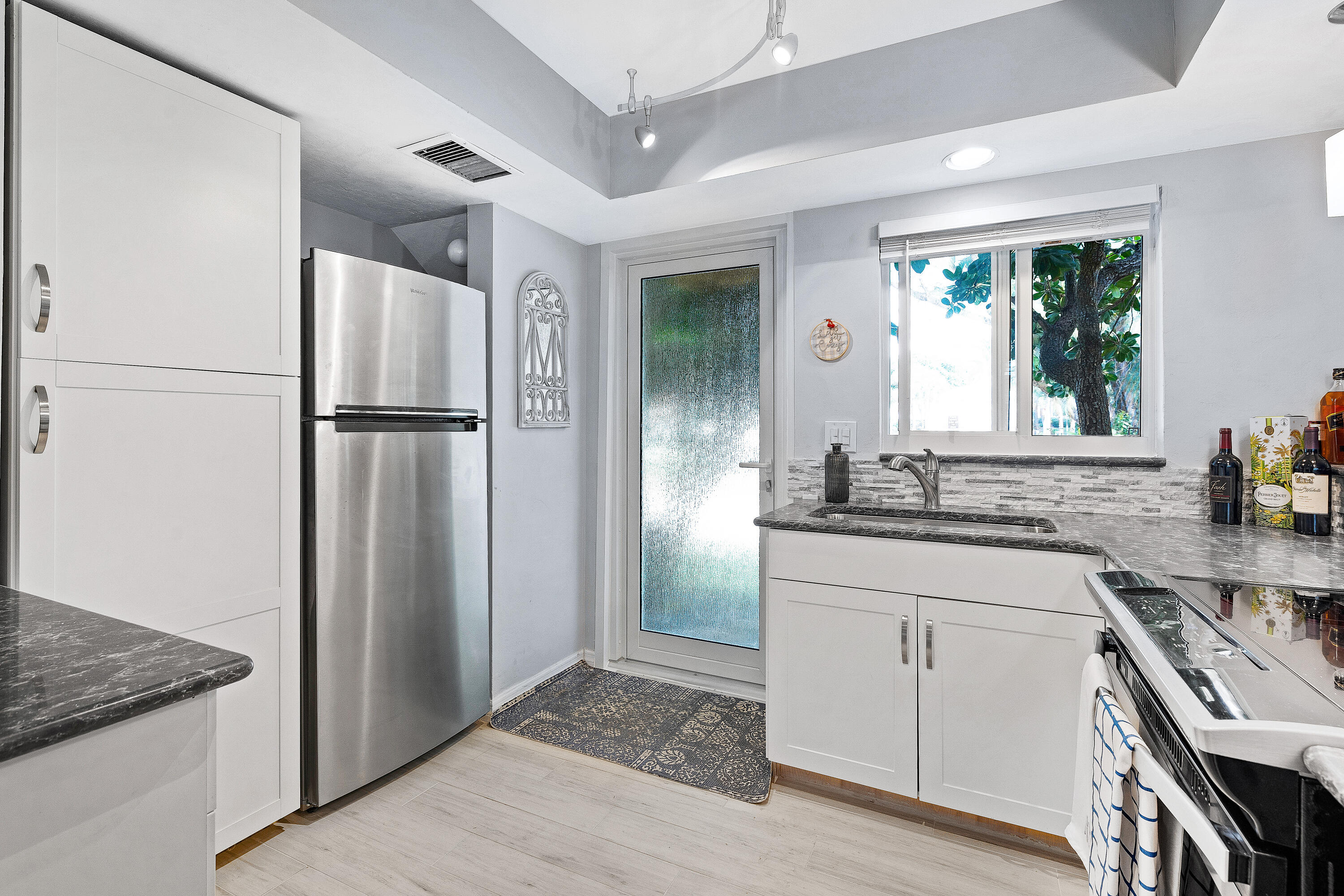 1030 Langer Way, Unit 5 Delray Beach, FL 33483 - Photo 6 of 21 a kitchen with a refrigerator sink and stove