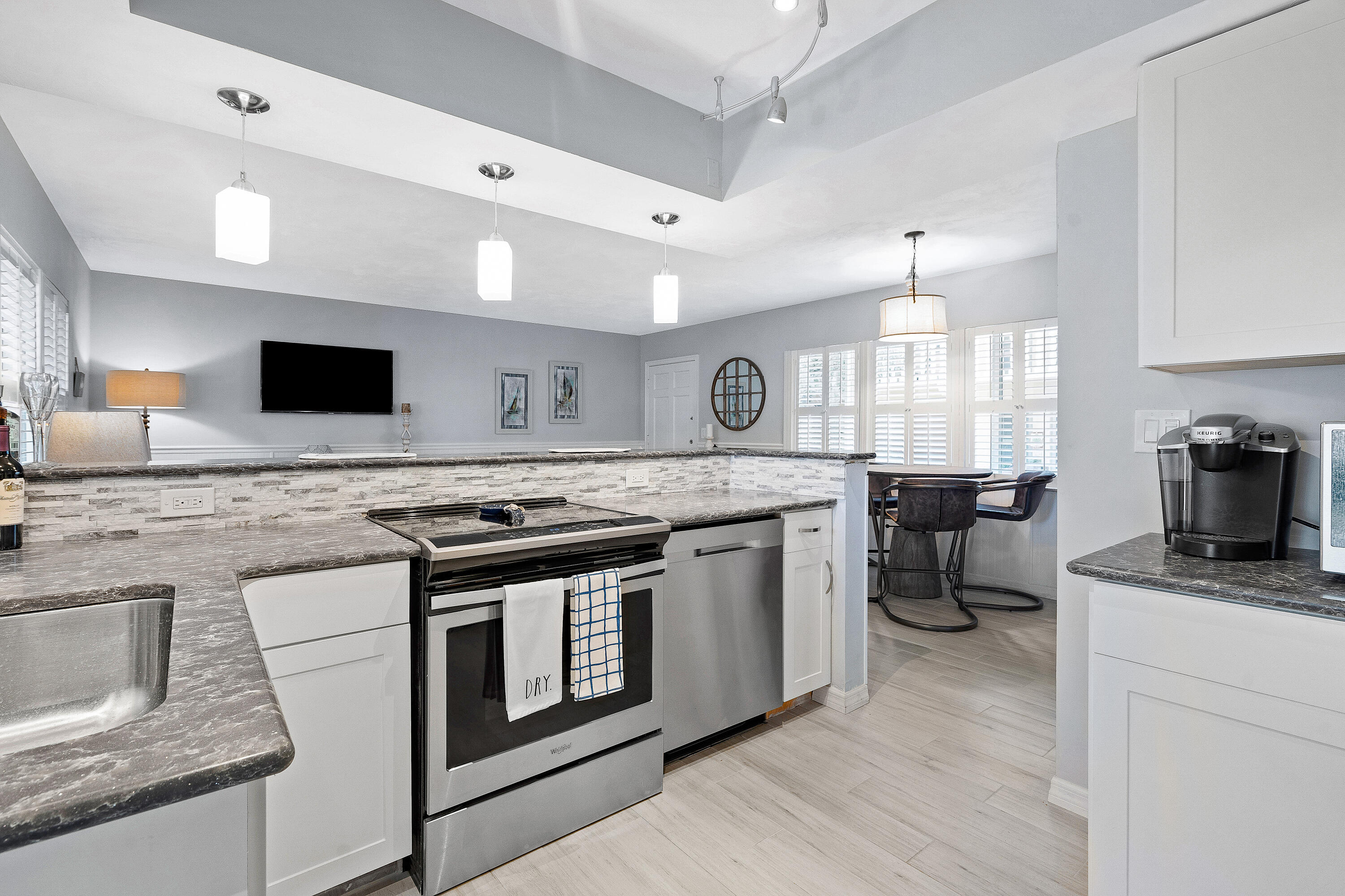 1030 Langer Way, Unit 5 Delray Beach, FL 33483 - Photo 7 of 21 a kitchen with a stove and a microwave