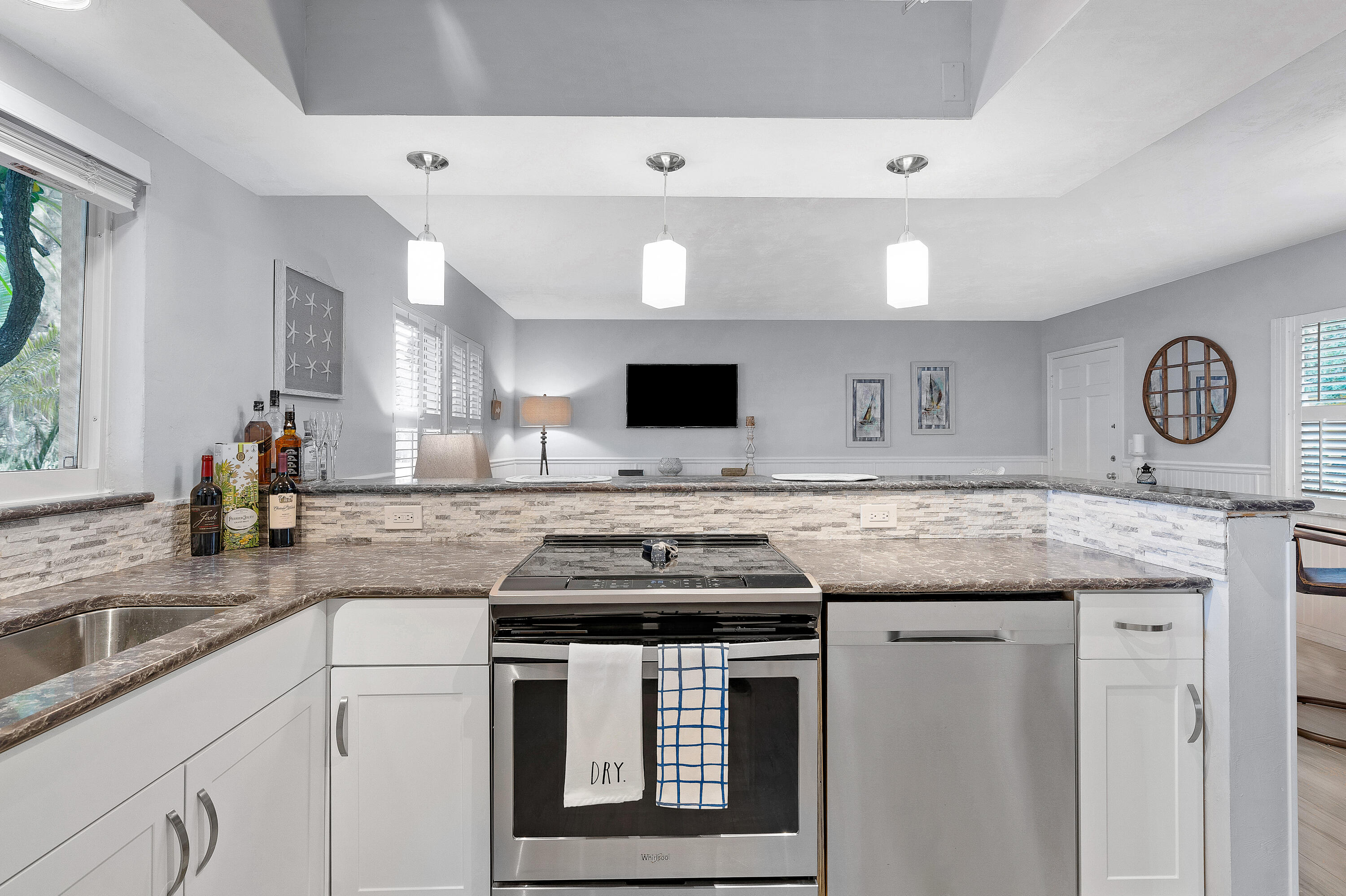1030 Langer Way, Unit 5 Delray Beach, FL 33483 - Photo 9 of 21 a kitchen with a stove and a sink