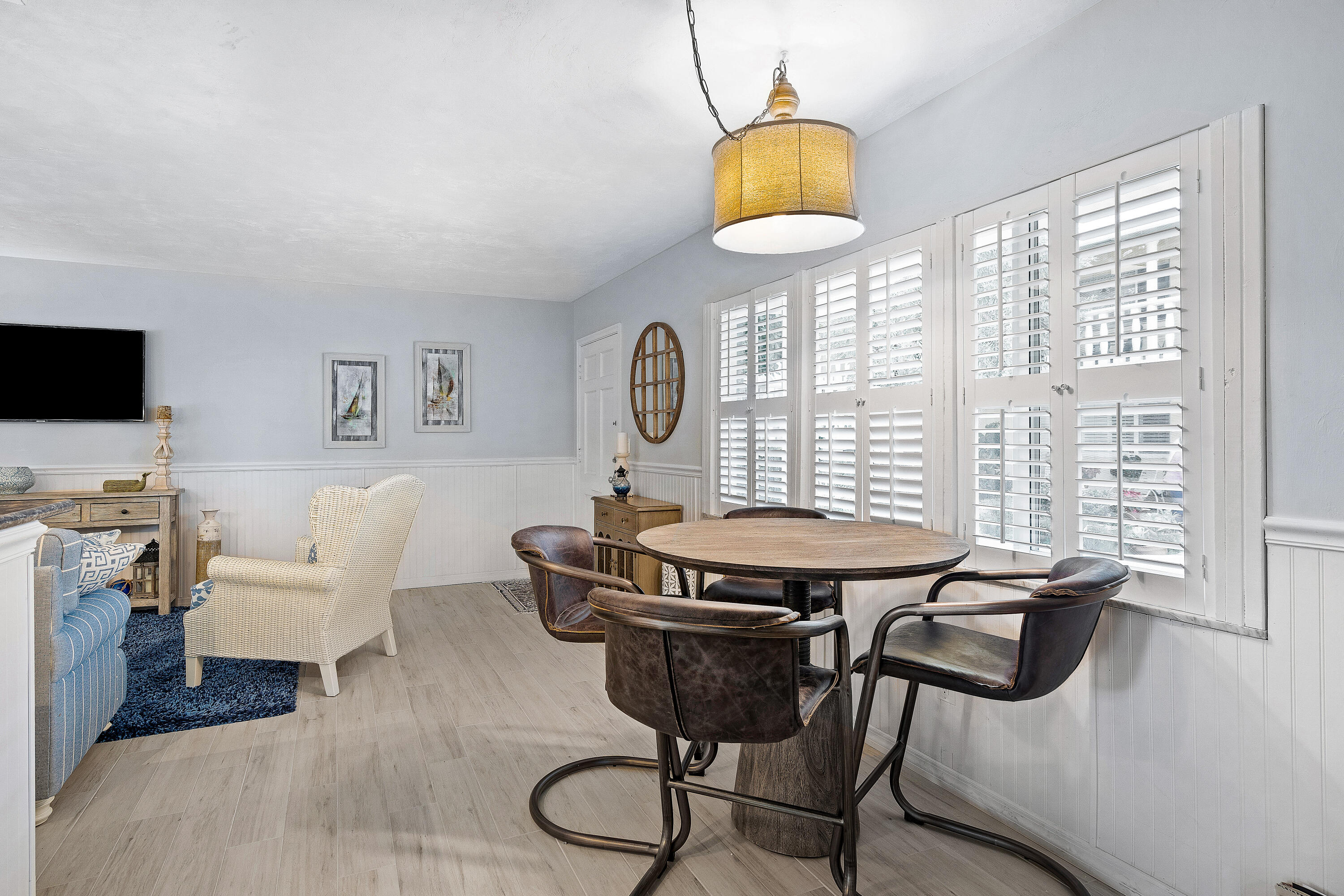 1030 Langer Way, Unit 5 Delray Beach, FL 33483 - Photo 10 of 21 a view of a dining room with furniture window and wooden floor