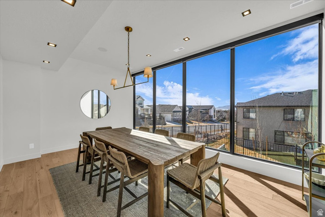 2152 South 30 West Orem, UT 84058 - Photo 25 of 56 Dining space with light wood-style floors, expansive windows, a residential view, and recessed lighting
