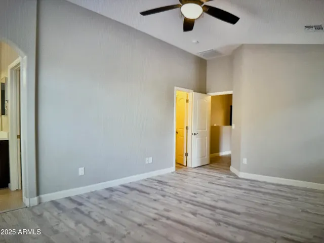 an empty room with a empty space and chandelier fan