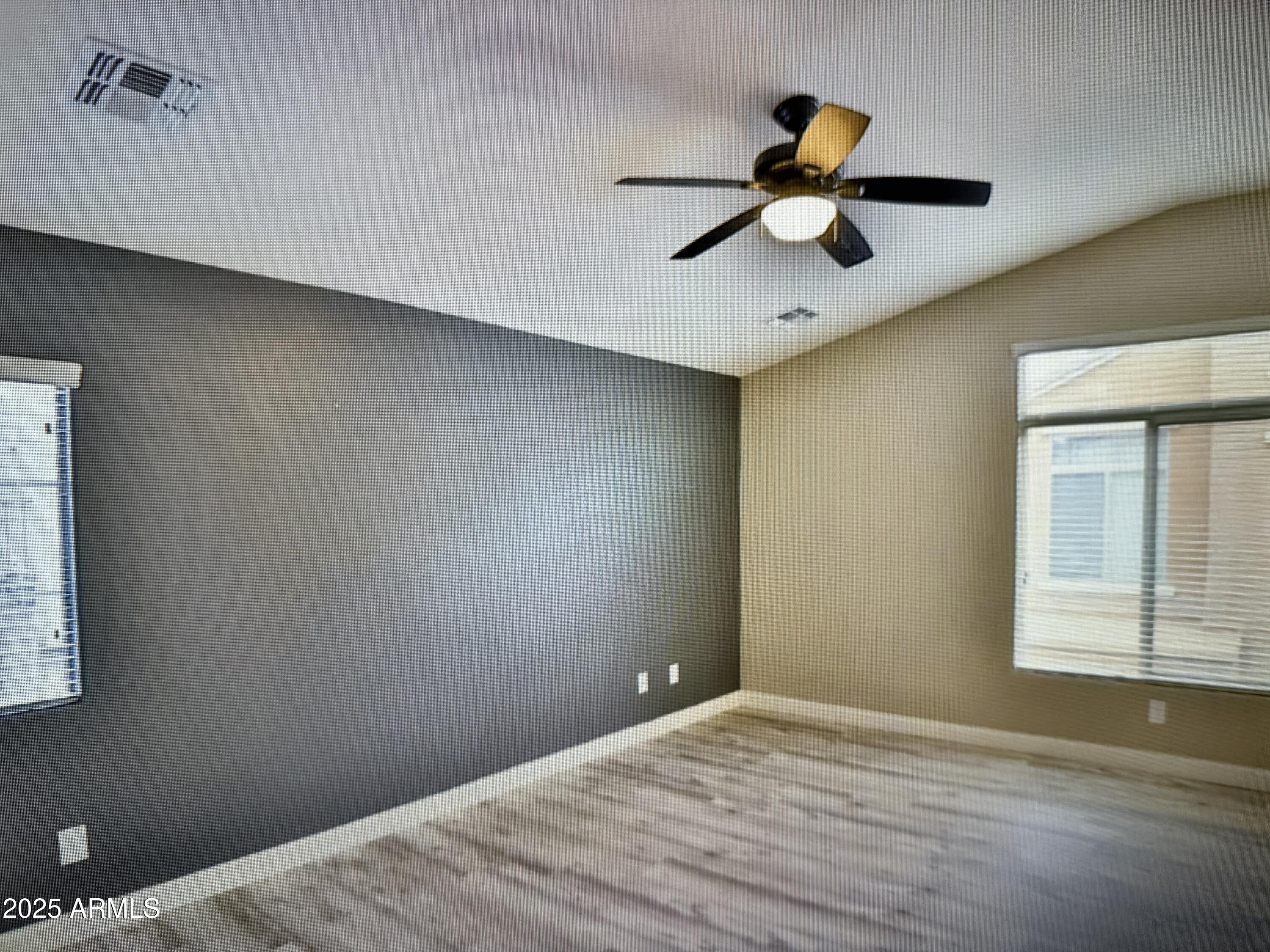 2150 West Alameda Road, Unit 1259 Phoenix, AZ 85085 - Photo 15 of 18 a view of empty room with window and wooden floor