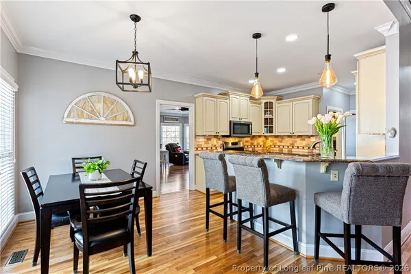 a view of a dining room with furniture window and wooden floor