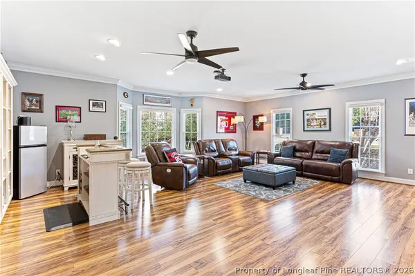 a living room with furniture and wooden floor