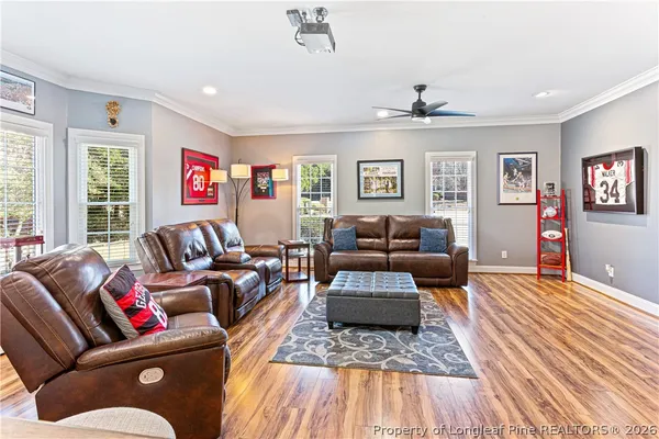 a living room with furniture and a wooden floor