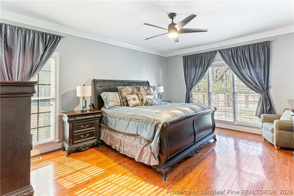 a bedroom with a bed and a television