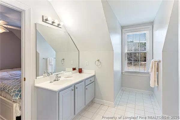 a living room with a bed furniture and a window