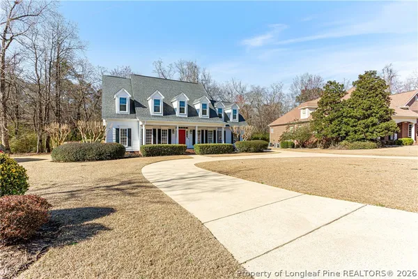 a view of a house with a tub and wooden chairs