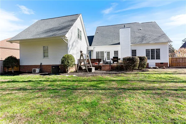 a view of a house with a yard and sitting area