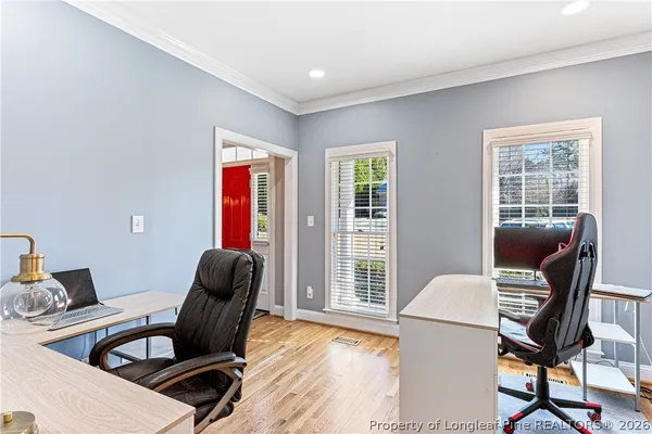 a view of staircase with wooden floor and white walls