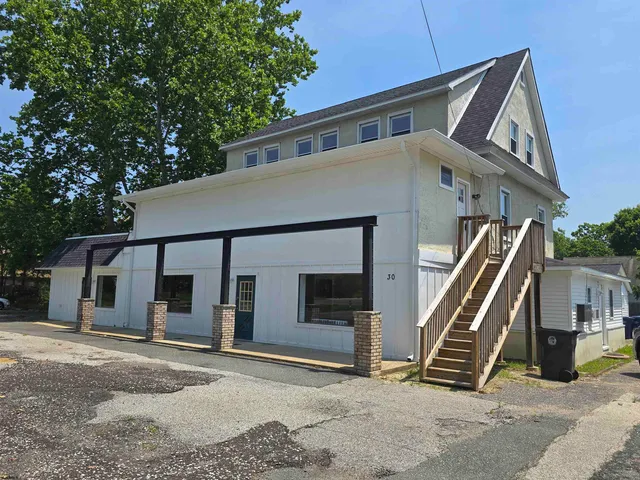 a front view of a house with stairs