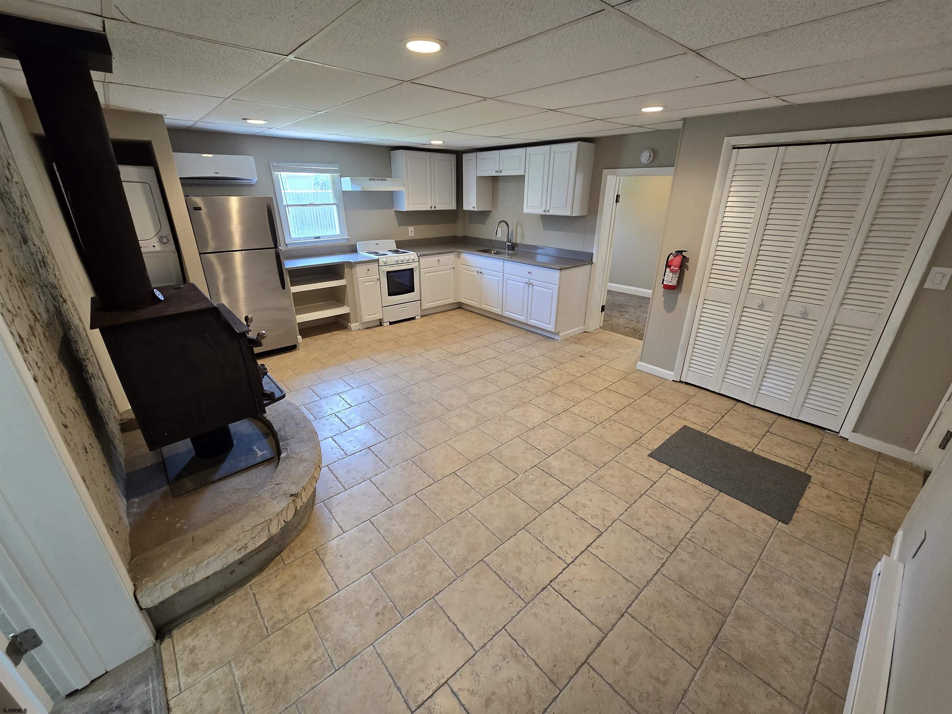 30 Mill Street, Unit C Mays Landing, NJ 08330 - Photo 4 of 15 a kitchen with stainless steel appliances a refrigerator and microwave
