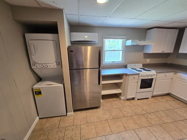 a kitchen with a refrigerator sink and cabinets